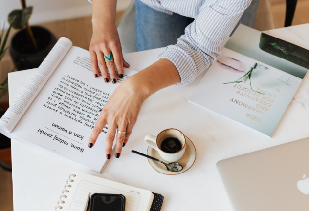 Image of person working on paper notes, only hands shown